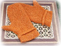 Broadside Mittens on woven table